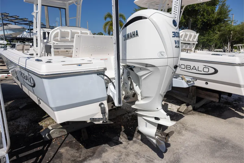 Slide: The Image of 2022 Robalo 246 Cayman SD boat with Yamaha 300 V6 engine, docked outdoors. - 3