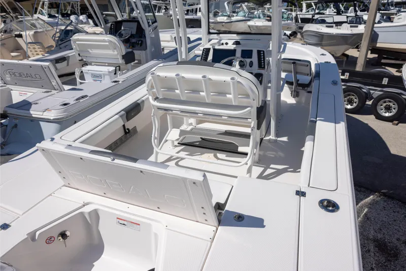 Slide: The Image of 2022 Robalo 246 Cayman SD boat interior with seating and control panel. - 4