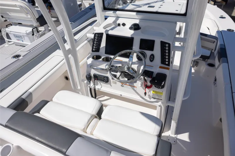 Slide: The Image of 2022 Robalo 246 Cayman SD boat cockpit with steering wheel and control panel. - 5