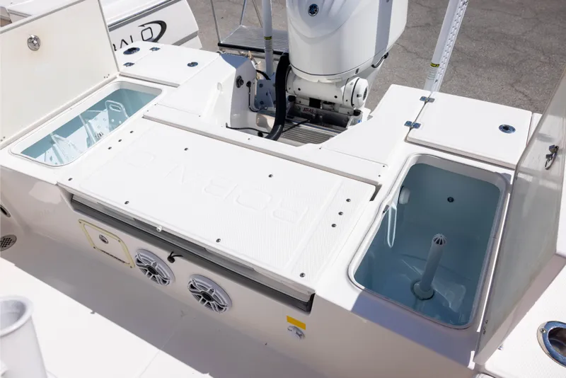 Slide: The Image of 2022 Robalo 246 Cayman SD boat deck with storage compartments and motor. - 7