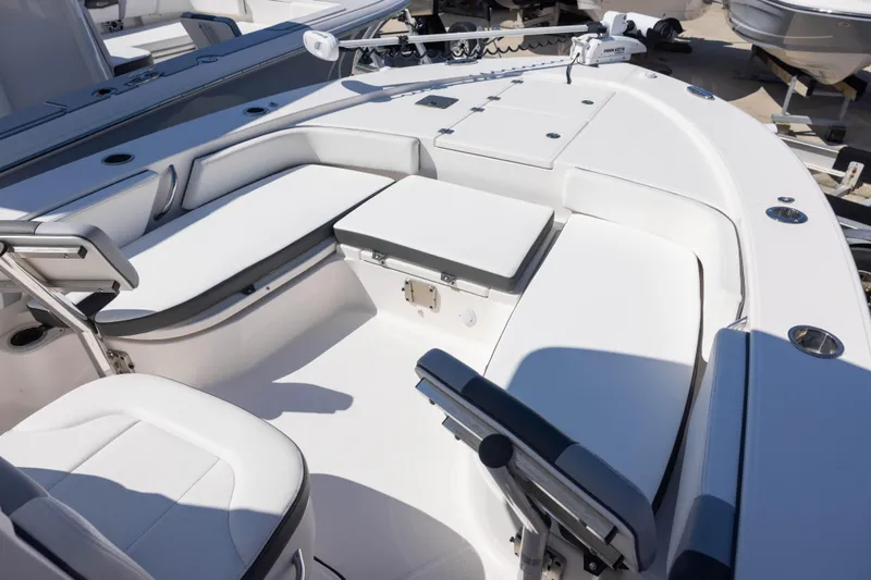 Slide: The Image of 2022 Robalo 246 Cayman SD boat interior with white seating and modern design. - 8