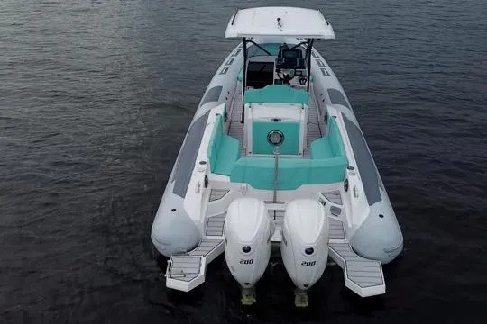 Slide: The Image of 2024 Ranieri Cayman 27.0 Sport boat with dual engines on calm water. - 11