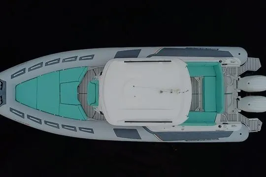 Slide: The Image of Top view of 2024 Ranieri Cayman 27.0 Sport boat with teal seating and twin engines. - 15