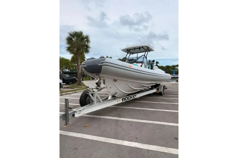 Slide: The Image of 2024 Ranieri Cayman 27.0 Sport boat on trailer in parking lot. - 18