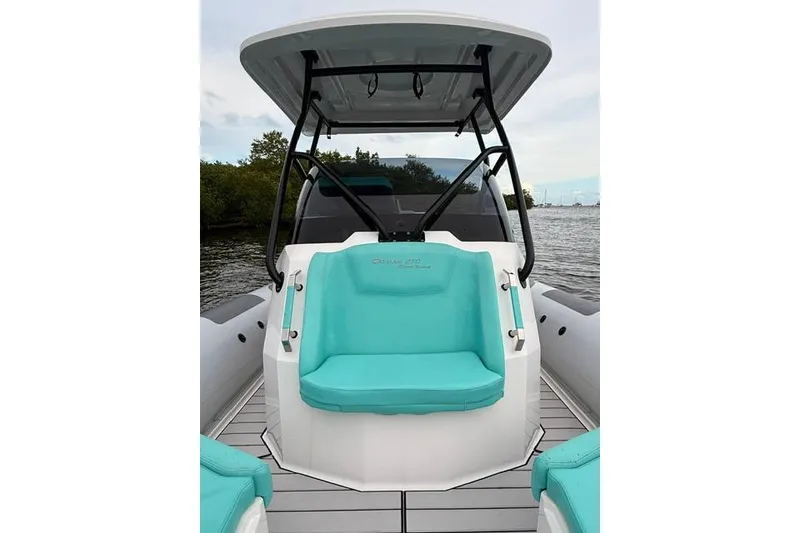 Slide: The Image of 2024 Ranieri Cayman 27.0 Sport boat with turquoise seating, docked by the water. - 19