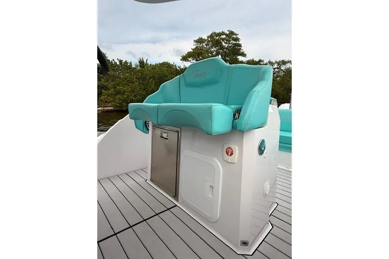 Slide: The Image of Turquoise seating on 2024 Ranieri Cayman 27.0 Sport boat, featuring sleek design and storage. - 20