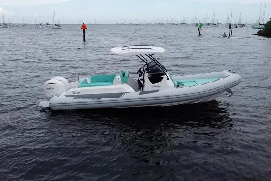 Slide: The Image of 2024 Ranieri Cayman 27.0 Sport boat on calm water, featuring sleek design and modern amenities. - 3
