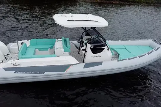 Slide: The Image of 2024 Ranieri Cayman 27.0 Sport boat with sleek design on calm water. - 6