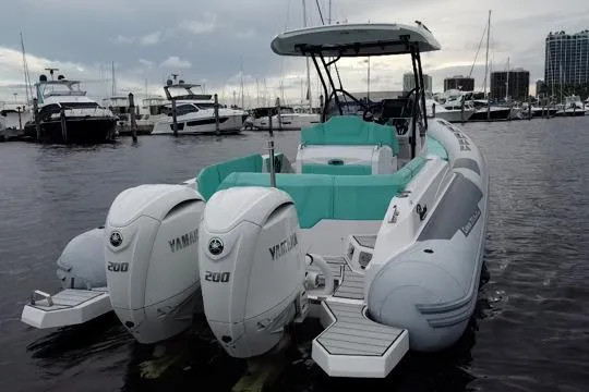 Slide: The Image of 2024 Ranieri Cayman 27.0 Sport boat with twin Yamaha 200 engines docked at marina. - 8
