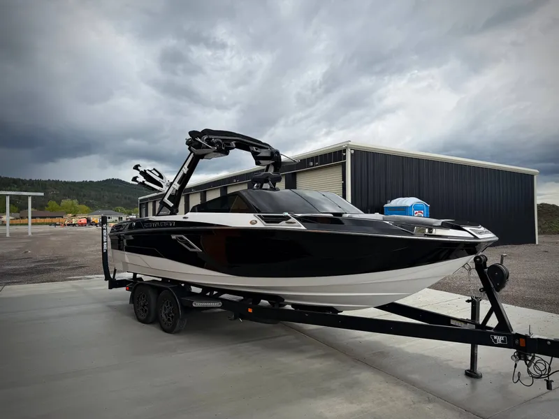 The Image of 2023 Centurion Ri230 boat on trailer under cloudy sky. - 1