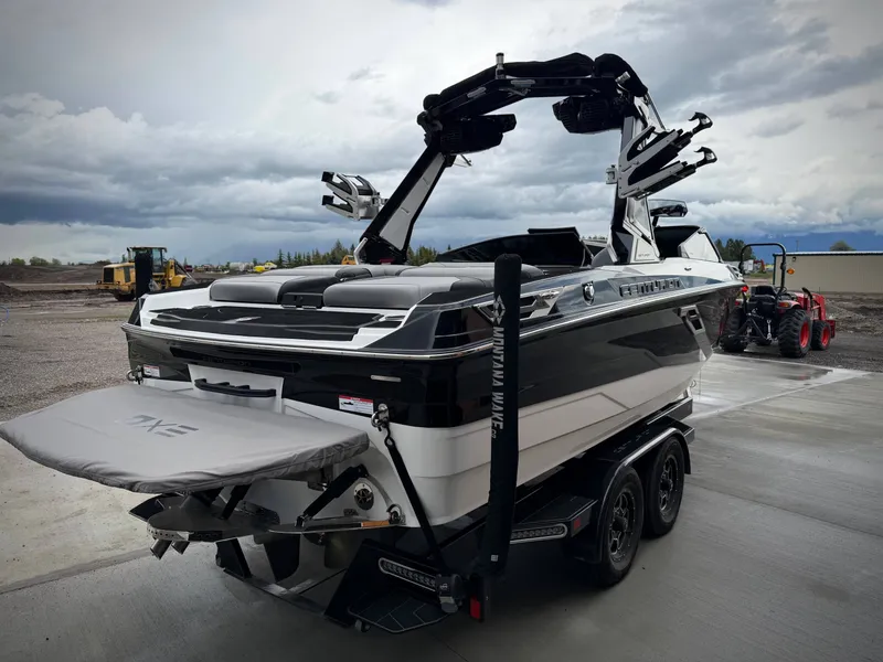 Slide: The Image of 2023 Centurion Ri230 boat on trailer under cloudy sky. - 5