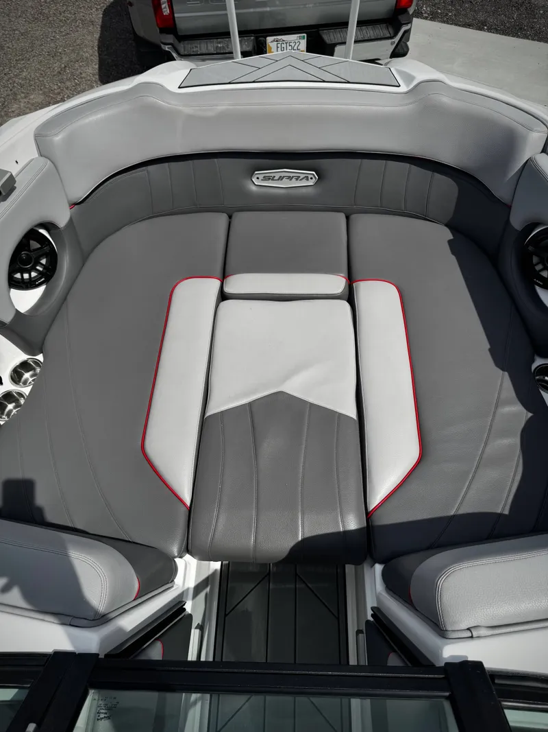 Slide: The Image of Interior of a 2020 Supra SE 550 boat with gray upholstery. - 11