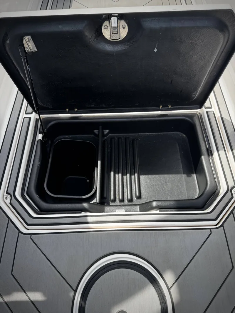 Slide: The Image of Open storage compartment in 2020 Supra SE 550 boat. - 15