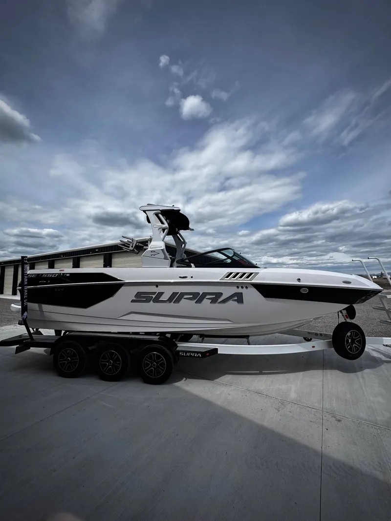 Slide: The Image of 2020 Supra SE 550 boat on trailer under cloudy sky. - 3