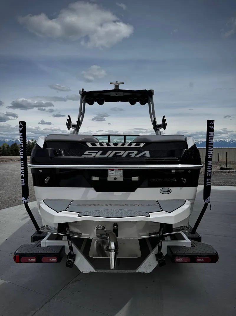 Slide: The Image of Rear view of a 2020 Supra SE 550 boat on a parking lot. - 5