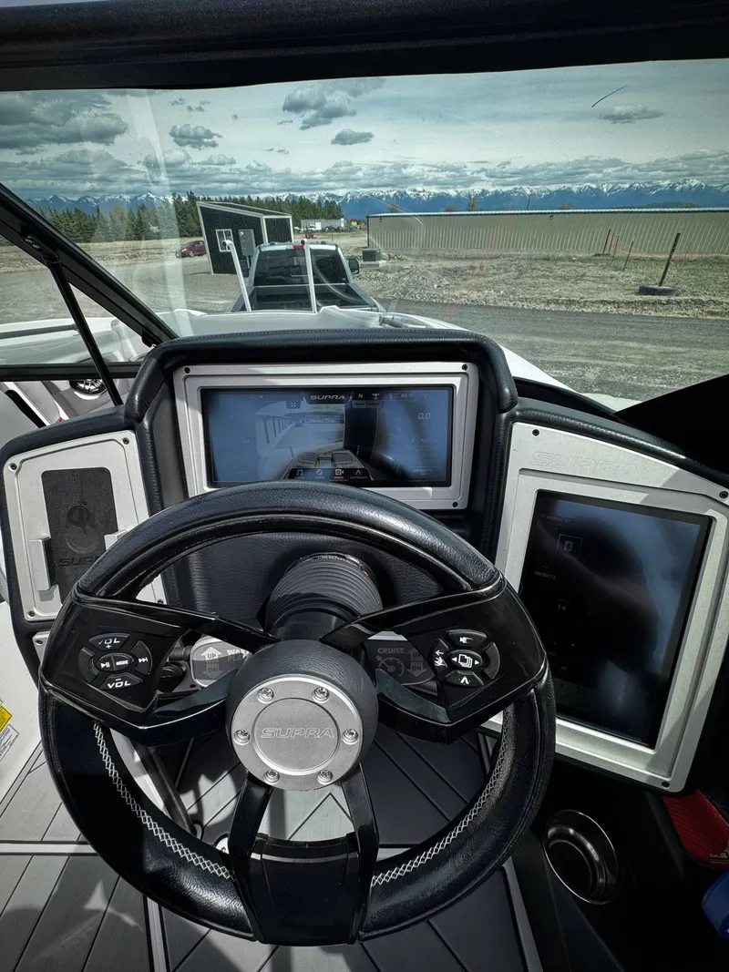 Slide: The Image of Interior view of 2020 Supra SE 550 boat with steering wheel and dashboard. - 8