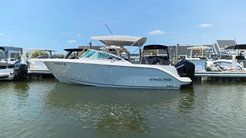 Slide: The Image of 2024 Sailfish 226 DC boat docked in harbor on a sunny day. - 0