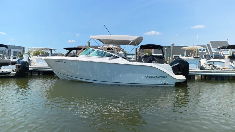 Slide: The Image of 2024 Sailfish 226 DC boat docked in harbor on a sunny day. - 1