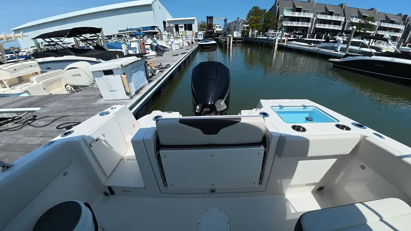 Slide: The Image of Sailfish 226 DC 2024 boat at dock with motor view. - 11