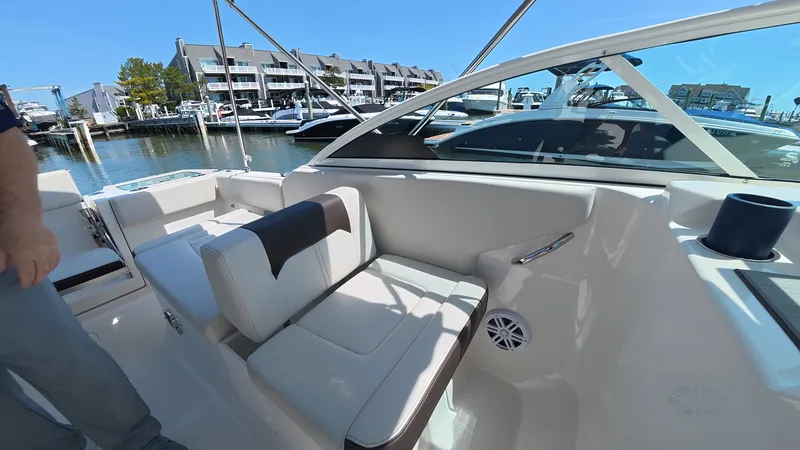 Slide: The Image of Interior of 2024 Sailfish 226 DC with comfortable seating at the marina. - 18