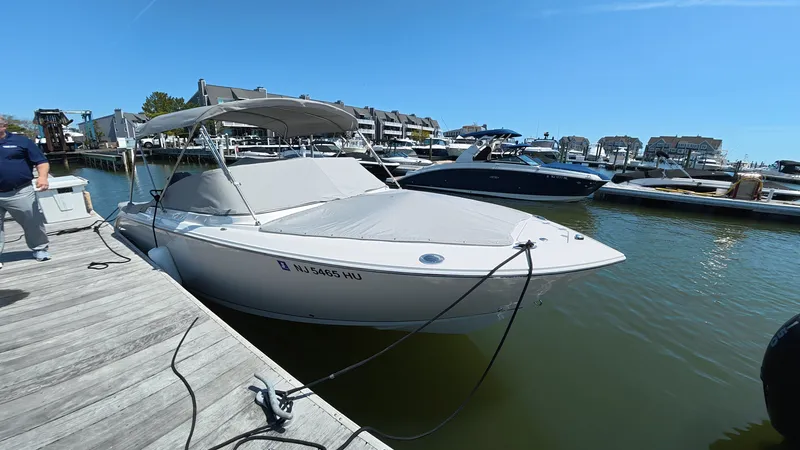 Slide: The Image of 2024 Sailfish 226 DC boat docked on a sunny day. - 4
