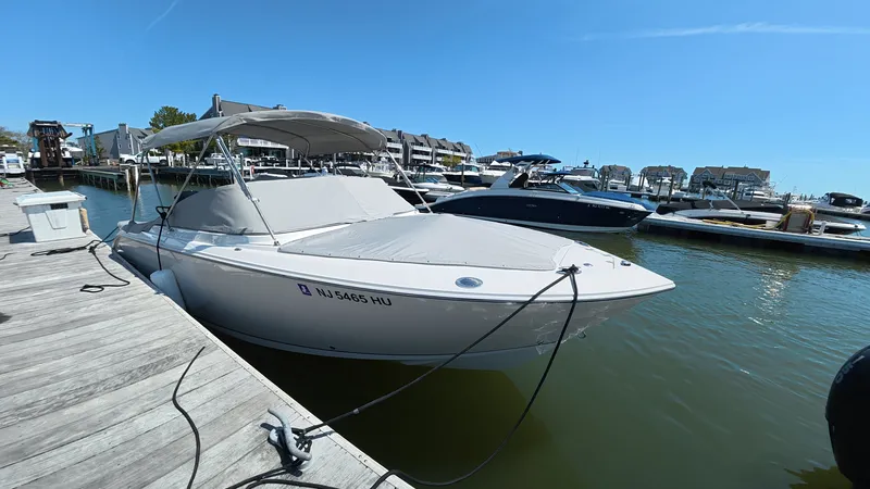 Slide: The Image of 2024 Sailfish 226 DC boat docked at marina. - 5