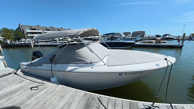 Slide: The Image of 2024 Sailfish 226 DC boat docked at marina. - 6