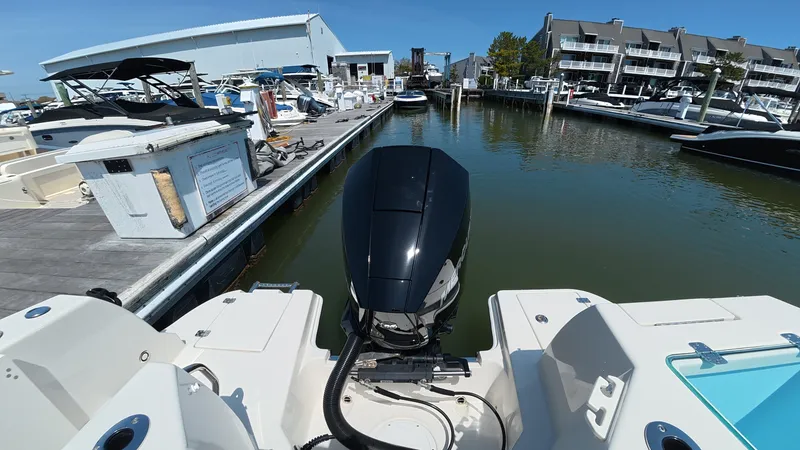 Slide: The Image of Sailfish 226 DC 2024 boat at dock with outboard motor. - 7