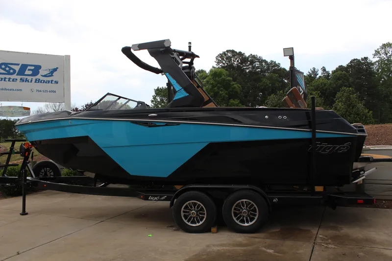 Slide: The Image of 2026 Tigé Z3 boat in blue and black on a trailer at Charlotte Ski Boats. - 6