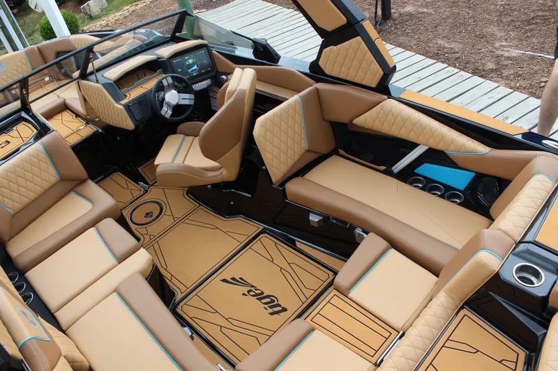Slide: The Image of Luxurious interior of 2026 Tigé Z3 boat with tan leather seating and modern dashboard. - 11