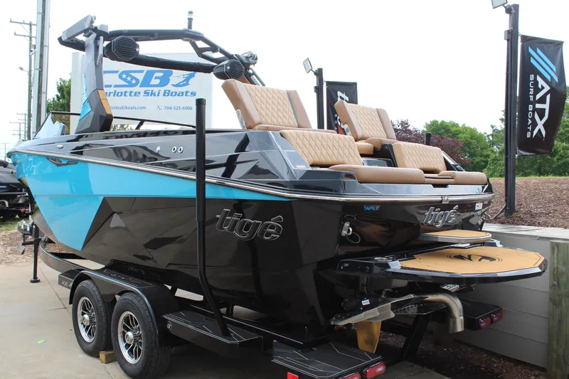 Slide: The Image of 2026 Tigé Z3 boat with sleek design, blue and black color, on a trailer at Charlotte Ski Boats. - 5