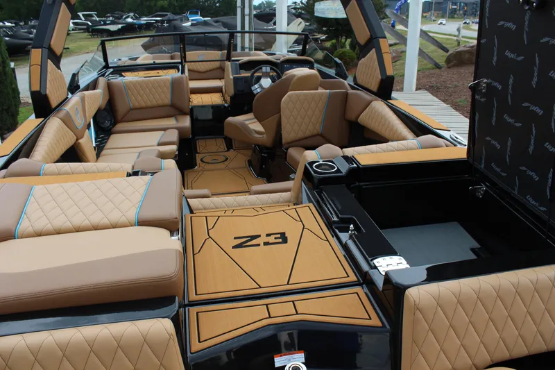 Slide: The Image of Luxurious interior of 2026 Tigé Z3 boat with tan quilted seating and modern design. - 9