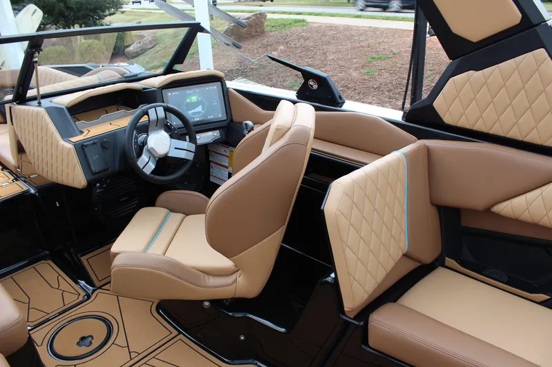 Slide: The Image of 2026 Tigé Z3 boat interior with tan leather seats and modern dashboard. - 14