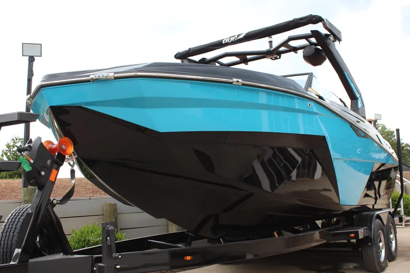 Slide: The Image of 2026 Tigé Z3 boat in vibrant blue on trailer, showcasing sleek design and modern features. - 7