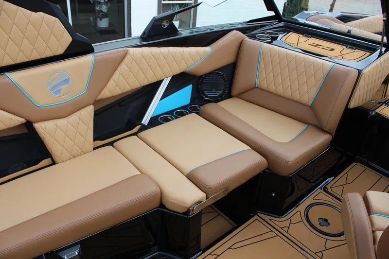 Slide: The Image of Luxurious interior of 2026 Tigé Z3 boat with tan and blue-accented seating. - 13