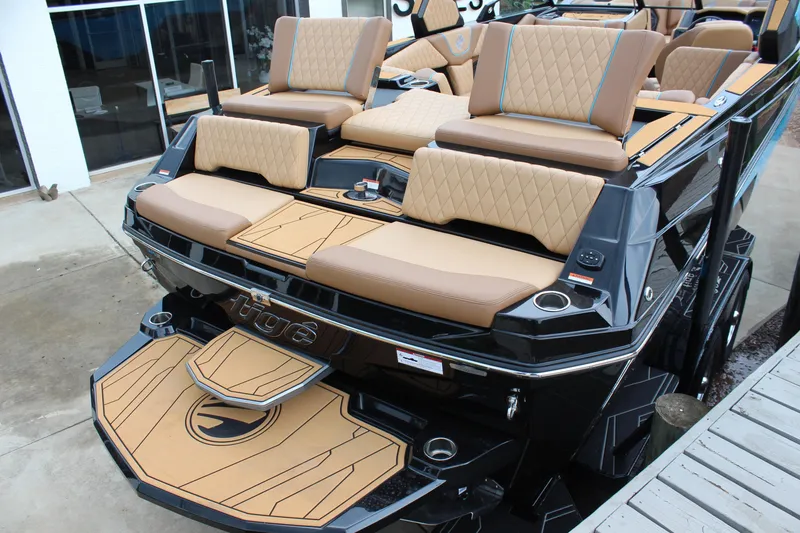 Slide: The Image of 2026 Tigé Z3 boat with luxurious tan seating and sleek black exterior design. - 8