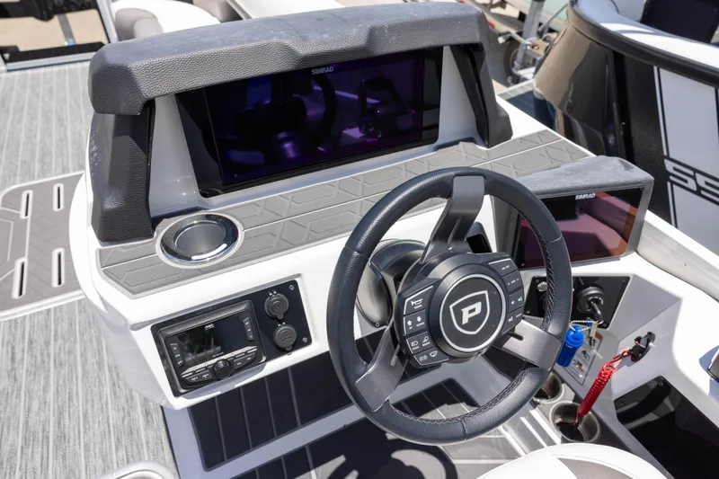 Slide: The Image of 2026 Premier 270 Intrigue RF - CL boat dashboard with steering wheel and navigation displays. - 11