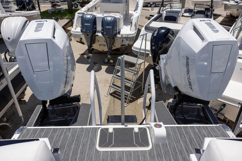 Slide: The Image of Premier 270 Intrigue RF - CL 2026 boat with dual Mercury outboard engines in a marina setting. - 8