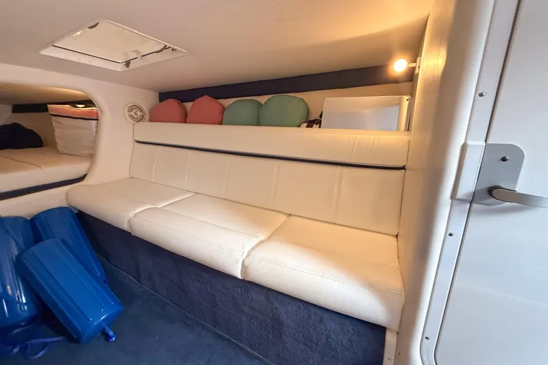 Slide: The Image of Interior of 2005 Donzi 38 ZR boat with white seating and colorful cushions. - 10
