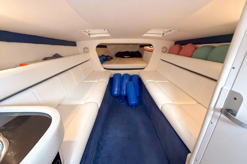 Slide: The Image of Interior of a 2005 Donzi 38 ZR boat with white seating and blue accents. - 11