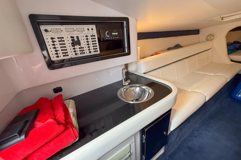 Slide: The Image of Interior of a 2005 Donzi 38 ZR boat with a sleek kitchenette and seating area. - 12