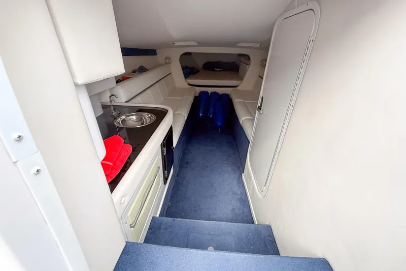 Slide: The Image of Interior of 2005 Donzi 38 ZR boat with kitchenette and seating area. - 13