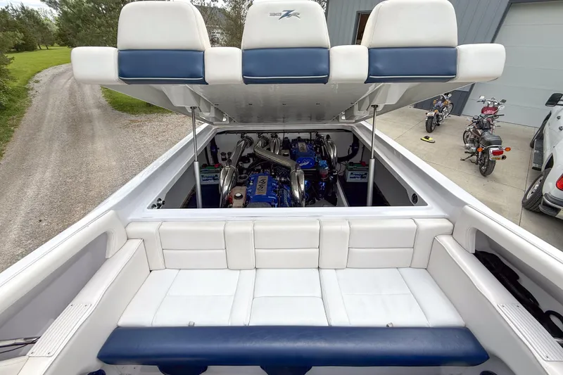 Slide: The Image of 2005 Donzi 38 ZR boat engine compartment with open hatch, showcasing powerful engines. - 14