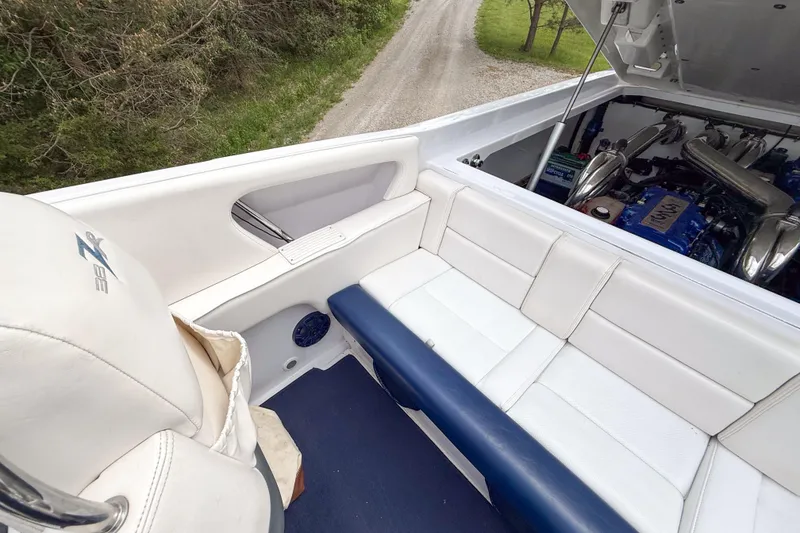 Slide: The Image of 2005 Donzi 38 ZR boat interior with white seating and visible engine compartment. - 16
