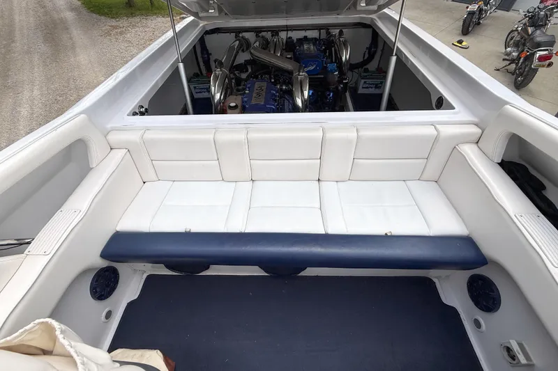 Slide: The Image of 2005 Donzi 38 ZR boat interior with white seating and visible engine compartment. - 18