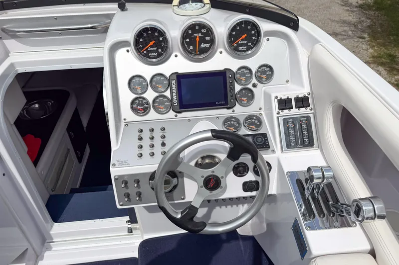Slide: The Image of Cockpit of a 2005 Donzi 38 ZR boat with steering wheel and control gauges. - 20
