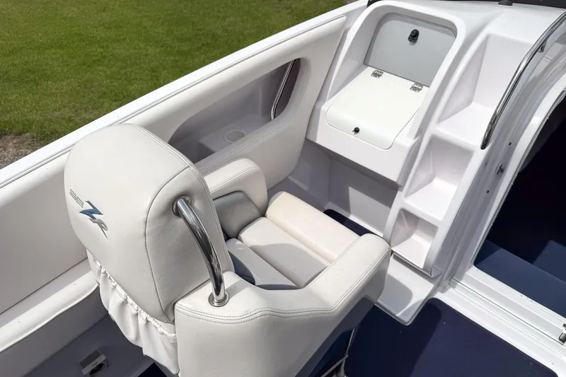 Slide: The Image of Interior of a 2005 Donzi 38 ZR boat featuring white seating and storage compartments. - 21