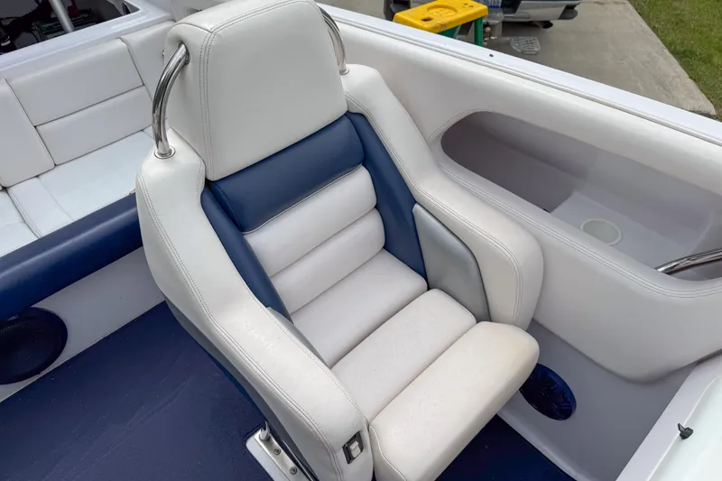 Slide: The Image of 2005 Donzi 38 ZR boat interior with white and blue cushioned seating. - 23