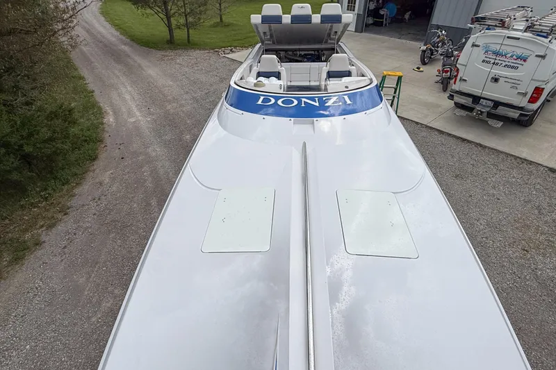 Slide: The Image of 2005 Donzi 38 ZR boat with sleek design, parked near a garage. - 25