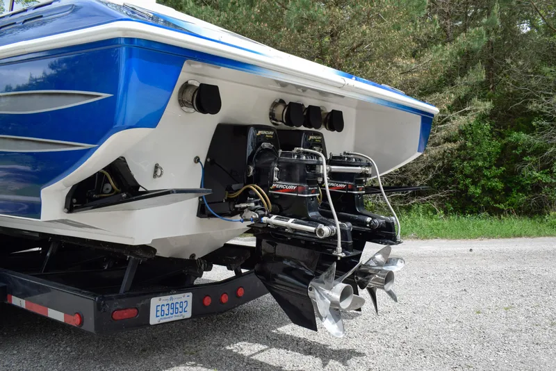 Slide: The Image of 2005 Donzi 38 ZR boat with dual Mercury engines on a trailer, parked outdoors. - 3